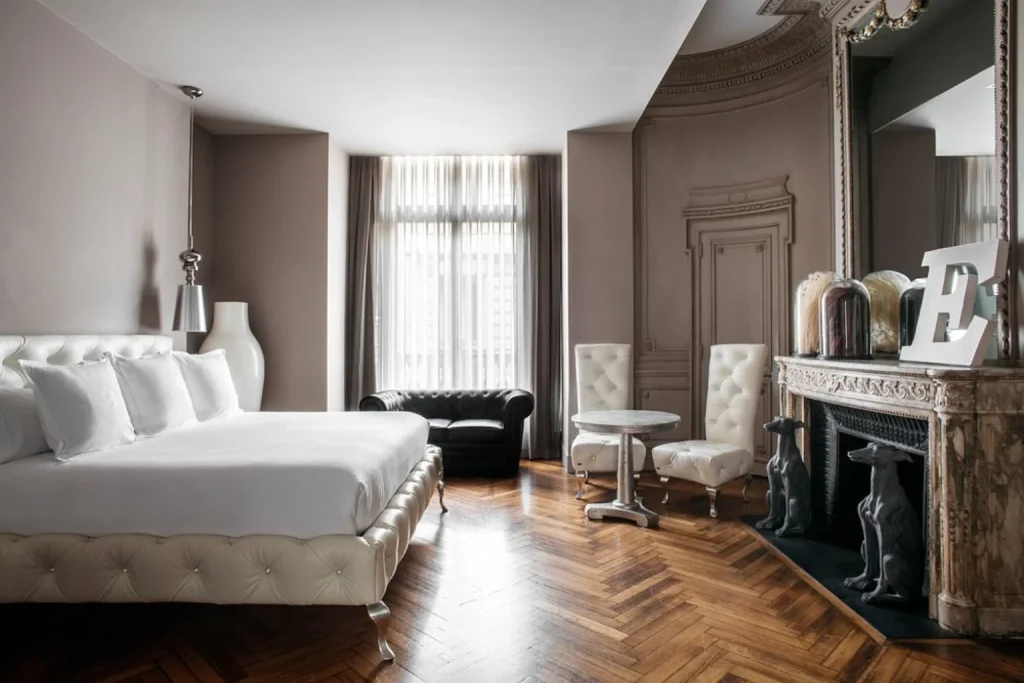 Elegant luxury guest room with marble fireplace and classic décor at Banke Opéra Paris, A Radisson Collection Hotel