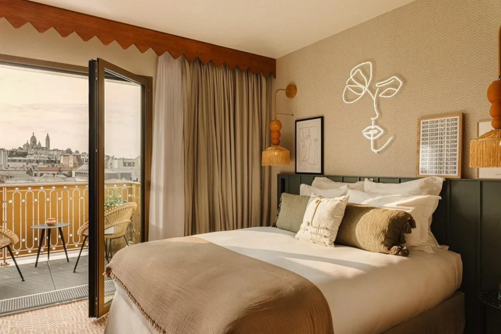 Stylish guest room with a private balcony and Sacré-Cœur view at Bloom House Hôtel in Paris