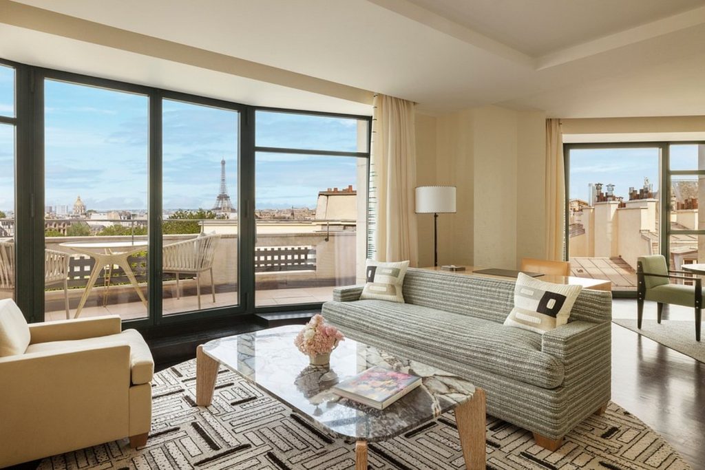 Spacious contemporary living room with a private terrace overlooking the Eiffel Tower and Paris skyline at Cheval Blanc Paris.