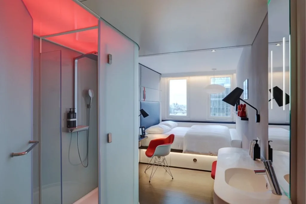 Modern guest room with contemporary bathroom and colorful design at citizenM Paris Gare de Lyon