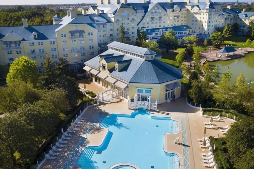 Outdoor swimming pool and hotel buildings at Disney Newport Bay Club, Disneyland Paris.