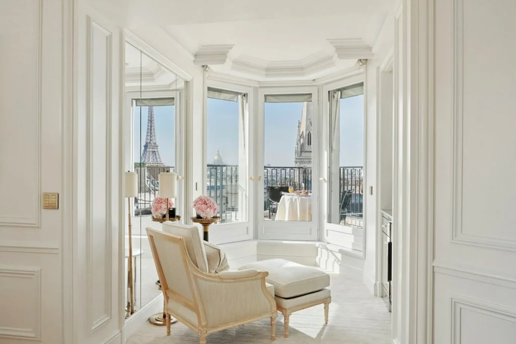 Luxurious Parisian suite featuring refined French interiors, elegant lounge seating, a private terrace and breathtaking views of the Eiffel Tower at Four Seasons Hotel George V in Paris.