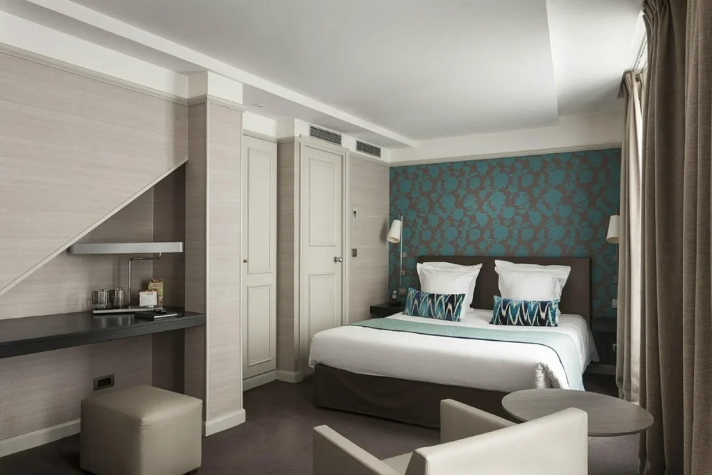 Stylish guest room with turquoise details, contemporary décor and a comfortable seating area at Hotel Duo, Paris, France