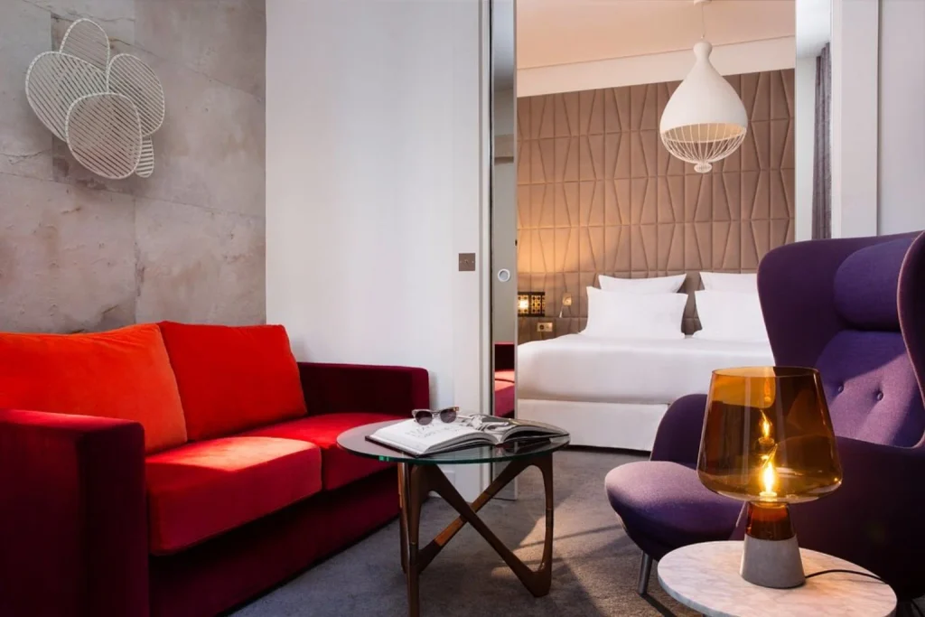 Colorful designer suite combining bold velvet furniture with a sophisticated modern bedroom at Hôtel Dupond-Smith, Paris, France