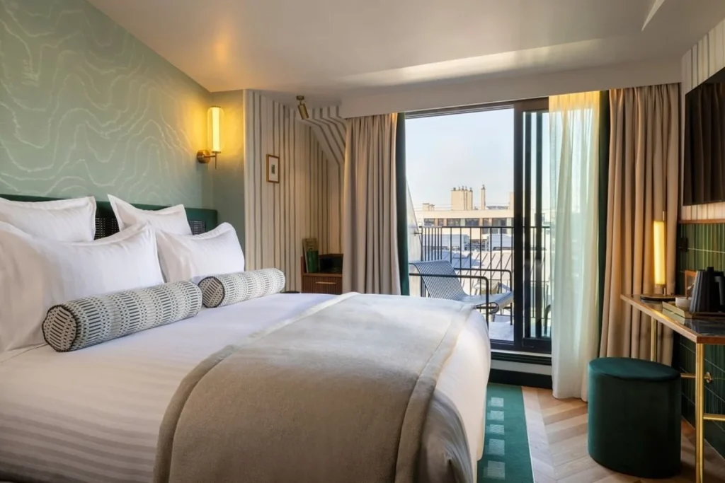 Elegant guest room with a private balcony at Hotel Filigrane & Spa in Paris