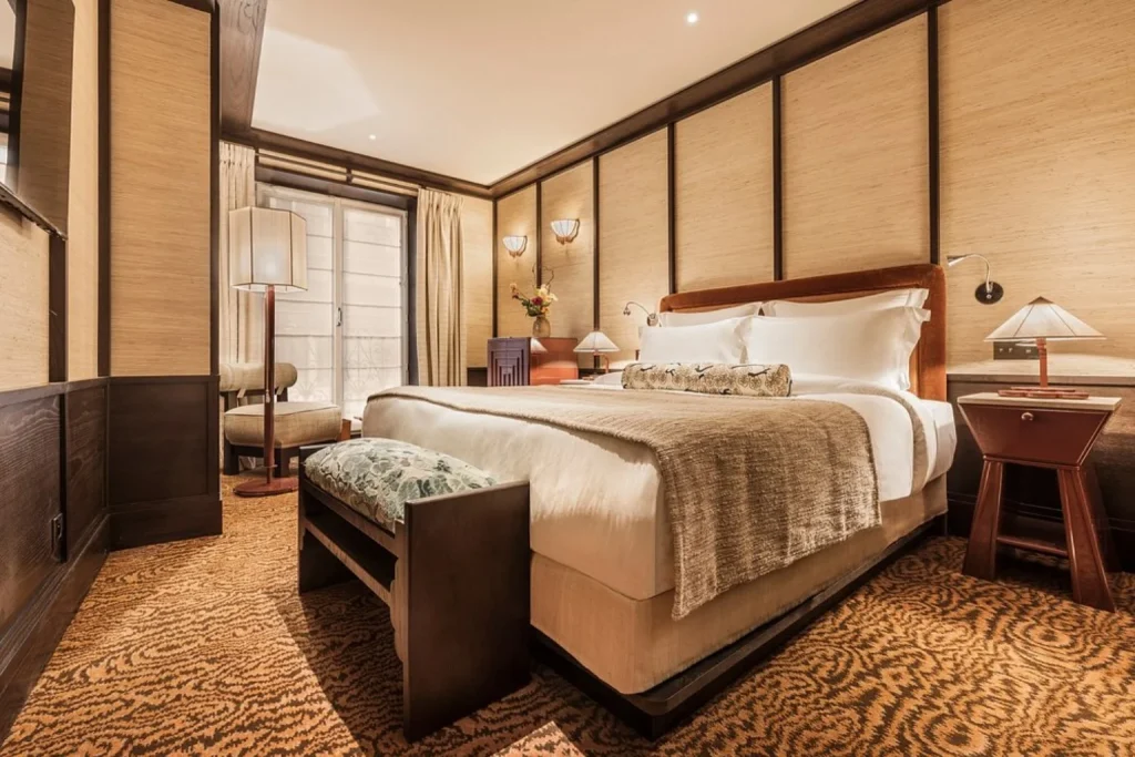 Elegant guest room with warm wood details and refined décor at Hotel Hana in Paris