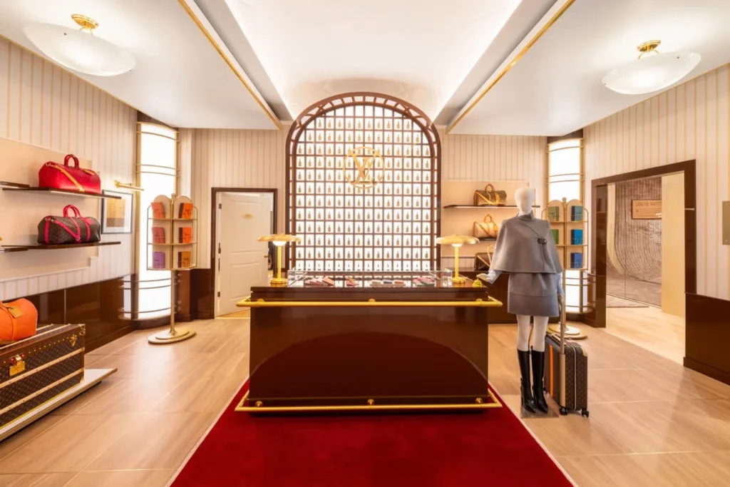 Elegant Louis Vuitton interior with luxury luggage displays and signature monogram details on the Champs-Élysées in Paris