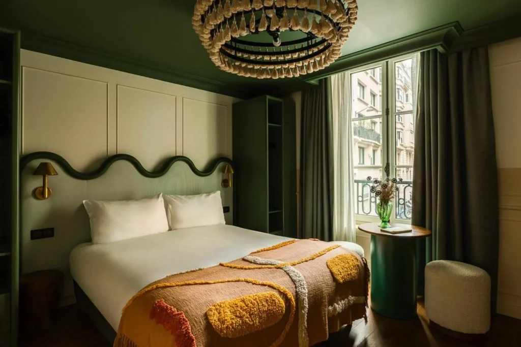 Stylish guest room with green interiors and contemporary décor at Le Jardin de Verre by Locke in Paris