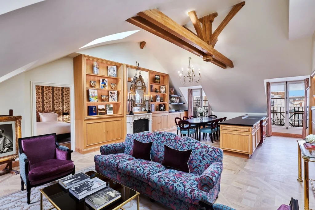 Spacious luxury suite at Maison Barrière Vendôme in Paris with exposed wooden beams, elegant furnishings and a bright living area
