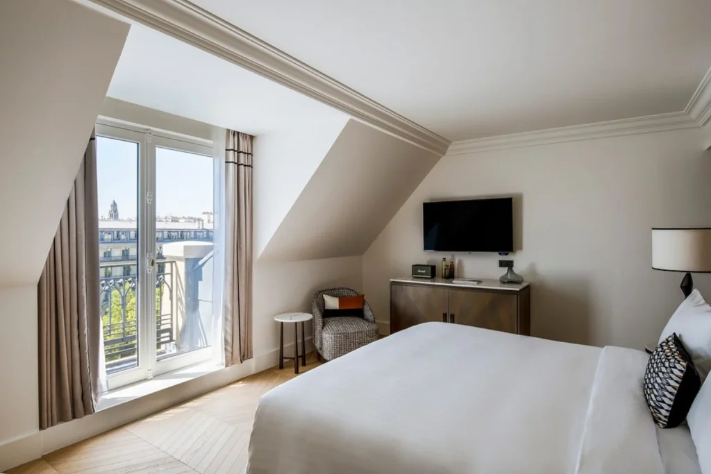 Elegant guest room with large windows and Paris city views at Paris Marriott Champs-Élysées Hotel