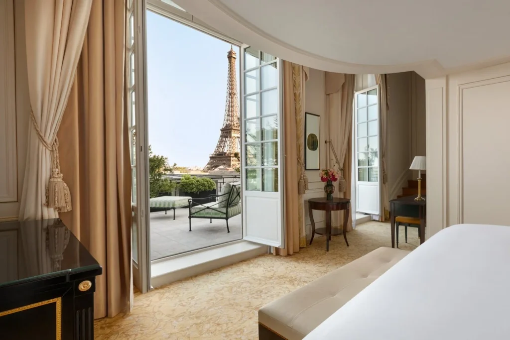 Luxury bedroom opening onto a private terrace with a direct view of the Eiffel Tower at Shangri-La Paris