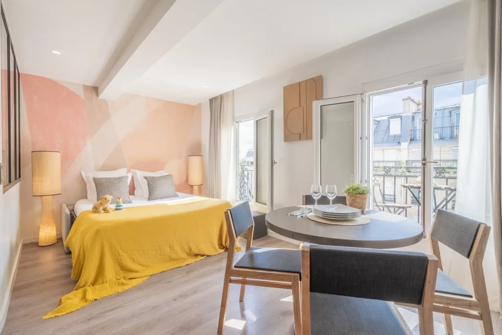 Bright apartment with double bed, dining area and private balcony at Yuna Les Halles in Paris